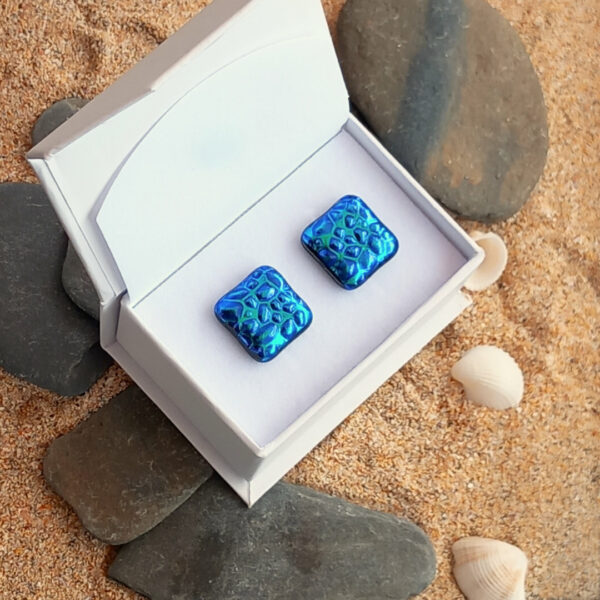 blue green ripple on pebbles