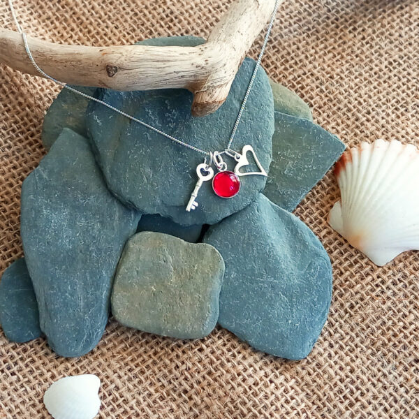 harlyn key and heart pendant over rocks